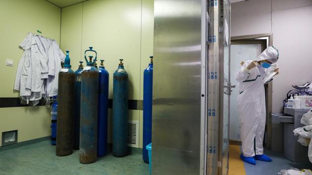A medical worker removes her protective suit after her shift at a hospital in Caidian district in Wuhan. Chinese officials and hospitals have repeatedly spoken of a shortage of protective equipment, including face masks. (China Daily via REUTERS)