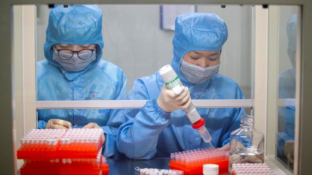 Workers at the production line manufacturing detection kits for the new coronavirus at a company, in Taizhou, Jiangsu province. Chinese scientists are testing two antiviral drugs and preliminary results are due in weeks, while the head of a Wuhan hospital told Reuters that plasma infusions from recovered patients had shown some encouraging preliminary results. (Cnsphoto via REUTERS)