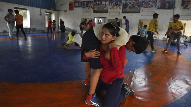 Saroha’s akhada now has girls from neighbouring states, for whom Saroha has built a hostel. It accommodates 10, with plans to expand the capacity to 60. Sunita, a wrestling coach from Haryana Sports Authority, is also posted at the centre. “Having a woman coach at the centre gives confidence to the parents that their daughter is in a safe environment,” said Sunita, who had trained to be a wrestler alongside Sakshi at Rohtak. (Biplov Bhuyan / HT Photo)