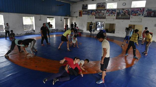 Women wrestlers at a Sonepat wrestling academy. Till a week before the national selection trials for the Tokyo Olympics qualifier, Sonam Mallik, 18, had never competed at the senior level. Yet her coach, Ajmer Malik, knew she was ready. Ajmer convinced the Wrestling Federation of India to give her a chance. She went on to beat Rio Olympics bronze medallist Sakshi Malik to seal a place in the Indian team. (Biplov Bhuyan / HT Photo)