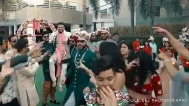 The groom sings along to the song while being carried by his groomsmen. (Instagram/@coolbluezphotography) The groom sings along to the song while being carried by his groomsmen. (Instagram/@coolbluezphotography)