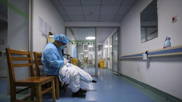 A doctor puts on a protective suit as he prepares to check on the patients at Jinyintan Hospital designated for new coronavirus infected patients, in Wuhan. (AP) A doctor puts on a protective suit as he prepares to check on the patients at Jinyintan Hospital designated for new coronavirus infected patients, in Wuhan. (AP)
