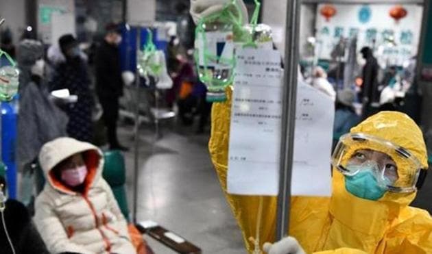 A medical worker in protective suit adjusts a drip bag for a patient at a hospital, following an outbreak of the new coronavirus in Wuhan, Hubei province, China February 3, 2020(REUTERS)