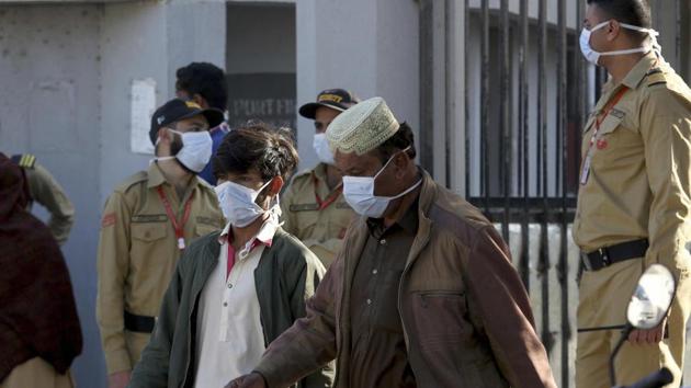 People and private guards wear masks while gather outside a hospital, where victims of toxic gas leak, are treated in Kamari neighbourhood of Karachi. A toxic gas leak killed 5 people and sickened dozens of others in a coastal residential area in Pakistan's port city of Karachi. (AP) People and private guards wear masks while gather outside a hospital, where victims of toxic gas leak, are treated in Kamari neighbourhood of Karachi. A toxic gas leak killed 5 people and sickened dozens of others in a coastal residential area in Pakistan's port city of Karachi. (AP)