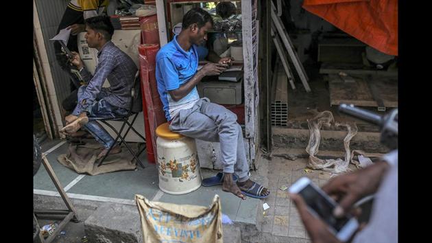 People use smartphones in Mumbai. The requirement comes as governments around the world are trying to hold social media companies more accountable for the content that circulates on their platforms, whether it’s fake news, child porn, racist invective or terrorism-related content. These new guidelines go further than most other countries’ by requiring blanket cooperation with government inquiries, no warrant or judicial order required. (Dhiraj Singh / Bloomberg)