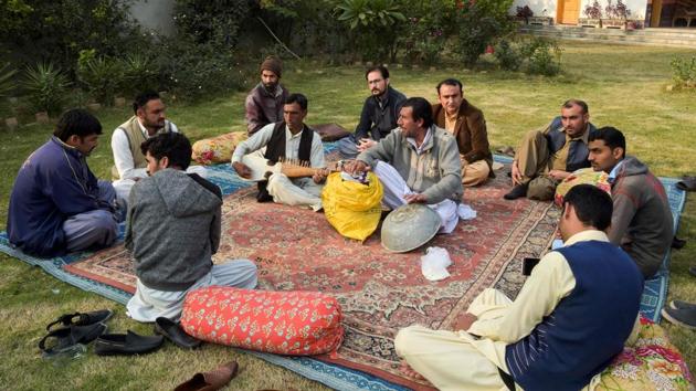 Akhtar Gul plays a traditional rabab musical instrument in Peshawar. In 2014, the Pakistani military began intensifying efforts to drive away militants from the country. Security has dramatically improved in the years since. “Now the situation is good, very good. We can play anywhere, whenever people invite us,” said rabab player Akhtar Gul during a performance at a hujra—a traditional Pashtun community space. (Abdul Majeed / AFP)