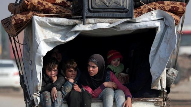 Displaced Syrians from northwest Syria ride on a back of a truck with belongings, in Azaz, Syria .(REUTERS)