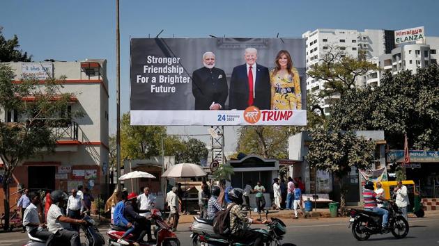 A hoarding with the images of Prime Minister Narendra Modi, US President Donald Trump and first lady Melania Trump ahead of Trump's visit, in Ahmedabad on February 18.(Reuters Photo) A hoarding with the images of Prime Minister Narendra Modi, US President Donald Trump and first lady Melania Trump ahead of Trump's visit, in Ahmedabad on February 18.(Reuters Photo)