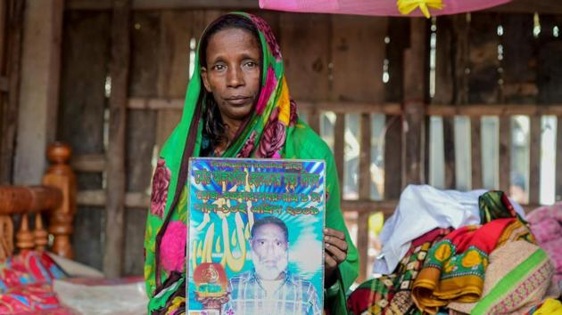Mosammat Rashida holds a portrait of her husband during an interview. “My sons have told me that I am an unlucky witch,” she told AFP in her flimsy plank home, in the honey-hunters’ village of Gabura at the edge of the Sundarbans— a 10,000-square-kilometre mangrove forest that straddles Bangladesh and India. Her husband died while out collecting honey in the jungles there. (Munir uz Zaman / AFP) Mosammat Rashida holds a portrait of her husband during an interview. “My sons have told me that I am an unlucky witch,” she told AFP in her flimsy plank home, in the honey-hunters’ village of Gabura at the edge of the Sundarbans— a 10,000-square-kilometre mangrove forest that straddles Bangladesh and India. Her husband died while out collecting honey in the jungles there. (Munir uz Zaman / AFP)