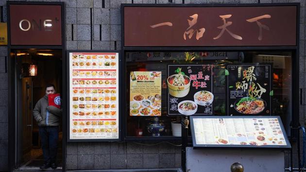 A worker waits for customers in London's Chinatown district. At the usually buzzing Empire Seafood Restaurant in Vancouver’s Richmond suburb for instance, getting a table is now a breeze. “Usually we’d have a large line-up time of approximately five-ten tables, but today there is no line up at all,” assistant general manager Ivan Yeung said. (Daniel Leal-Olivas / AFP)
