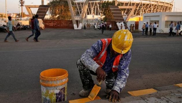 A worker paints footpath in front of Sardar Patel MoteraStadium, which Trump and Modi will inaugurate and also address a gathering at. Over a lakh people are expected to turn up for an event on the lines of the ‘Howdy Modi’ function that was addressed by the US President and Prime Minister Narendra Modi in Houston in September last year. (Amit Dave / REUTERS)