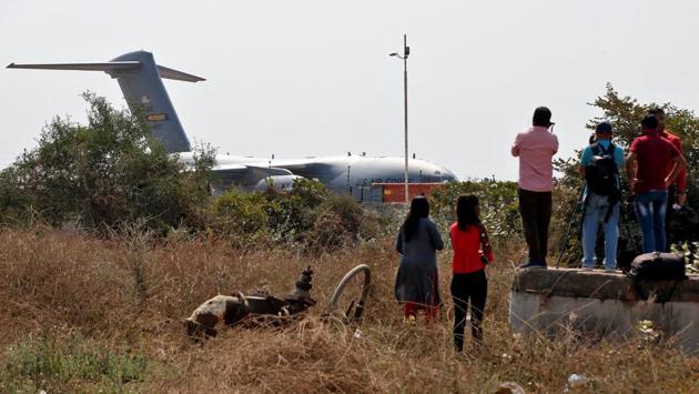 Members of the media film a US cargo aircraft carrying a vehicle and other supplies after its landing at Sardar Vallabhbhai Patel International Airport, ahead of the President Donald Trump's visit to India. With capacity for 110,000 spectators, the Motera Stadium will dislodge the Melbourne Cricket Ground as the world’s largest cricket stadium. (Amit Dave / REUTERS)