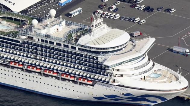 The U.S.-operated Diamond Princess is anchored as emergency vehicles stand by at Yokohama Port, near Tokyo.(AP)