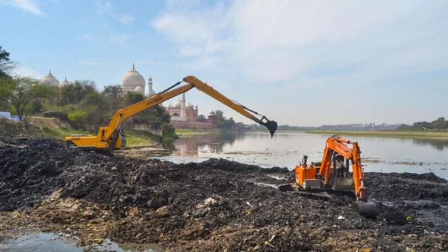 Earthmovers remove debris from the Yamuna river bed near Taj Mahal, ahead of the US President Donald Trump’s visit, in Agra, Wednesday, Feb. 19, 2020. (PTI) Earthmovers remove debris from the Yamuna river bed near Taj Mahal, ahead of the US President Donald Trump’s visit, in Agra, Wednesday, Feb. 19, 2020. (PTI)