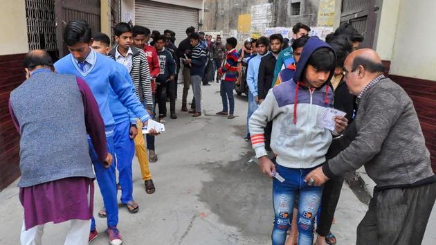 Security personnel frisk examinees before entering the examination hall to appear in the Uttar Pradesh Madhyamik Shiksha Parishad (UPMSP Board) high school (class 10th) and intermediate (class 12th) exams, in Moradabad(PTI)