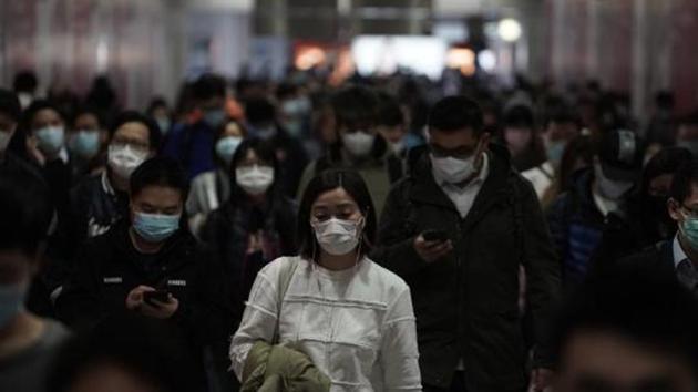 People wearing masks, walk in a subway station, in Hong Kong. (AP Photo) People wearing masks, walk in a subway station, in Hong Kong. (AP Photo)