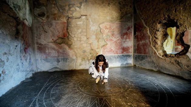 Archaeologists discovered in October a vivid fresco depicting an armour-clad gladiator standing victorious as his wounded opponent gushes blood, painted in a tavern believed to have housed the fighters as well as prostitutes. And in 2018, an inscription was uncovered that proves the city was destroyed after October 17, 79 AD, and not on August 24 as previously believed. (Alessandro Pone / LaPresse via AP)