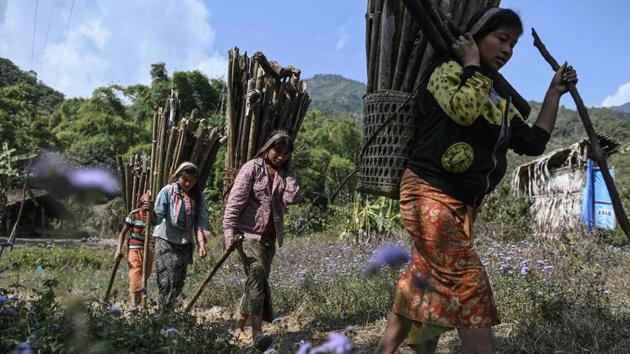 Women carry wood for a camp-fire for the upcoming overnight ceremony to bless the harvest. The group are part of the Naga, a blanket term for dozens of tribes each with their own distinct dialect living near the Indian border, only accessible by nerve-shredding motorcycle journeys and on foot. (Ye Aung Thu / AFP)