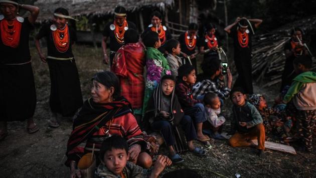 Villagers watch the end of the ceremony. It will be the men’s turn in a few weeks’ time, once the newly designated land is fully cleared and ready for planting. (Ye Aung Thu / AFP)
