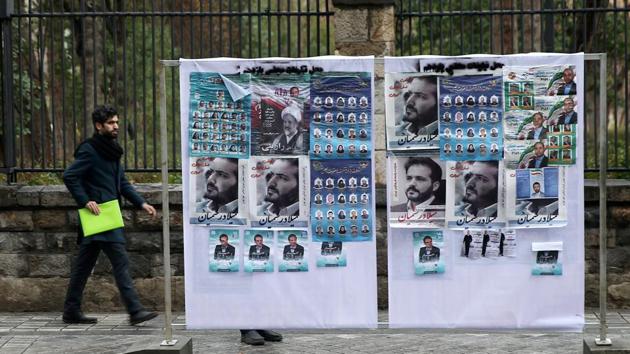 A man walk near parliamentary election campaign posters in Tehran, Iran, February 20, 2020. (VIA REUTERS) A man walk near parliamentary election campaign posters in Tehran, Iran, February 20, 2020. (VIA REUTERS)