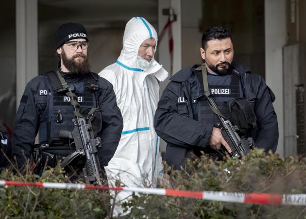 German police officers guard the entrance of a bar where several people were killed late Wednesday in Hanau, Germany. (AP Photo) German police officers guard the entrance of a bar where several people were killed late Wednesday in Hanau, Germany. (AP Photo)