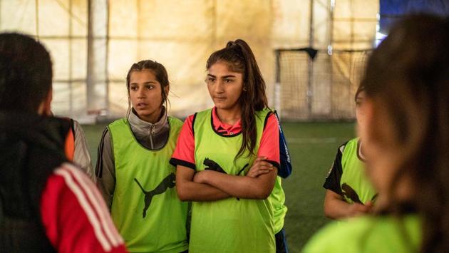 Members of the Amuda women's team listen to directions from their coach. Sheikh came back to it more determined than ever to overcome social and gender prejudice and it all paid off when it was with cheers that a crowd greeted her and her team off the bus after winning the national trophy. (Delil Souleiman / AFP)