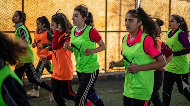 “I used to watch my brothers play and I’ve watched a lot of games,” she told AFP, as her teammates, all wearing fluorescent bibs, jogged behind the coach on the artificial grass of the covered pitch. (Delil Souleiman / AFP)