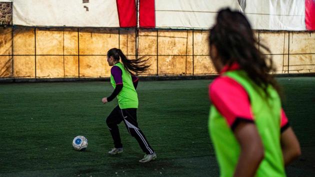 Members of the Amuda women's team in a training session. The young Kurdish woman, sweat pearling down her face and her ruffled hair in a ponytail, recounted how she started playing when she was 15 but had to stop “because of the criticism from her family and neighbours.” (Delil Souleiman / AFP)