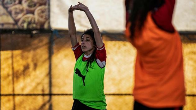 Members of the Amuda women's team during practice. Dalaf Hussein, another team member, faced the same challenges as a teenage girl trying to live her passion for football in northeastern Syria. Plastered on the walls of her room are posters of her favourite players, including one of Portuguese legend and Real Madrid star Cristiano Ronaldo. (Delil Souleiman / AFP)