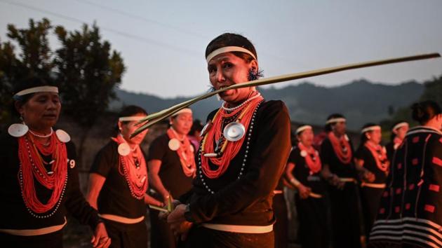 A Naga tribeswoman bites on a coconut leaf near the end of the overnight ceremony. A struggle for independence waged by armed factions on both sides has simmered for decades and yearning for a united Nagaland remains strong. (Ye Aung Thu / AFP)