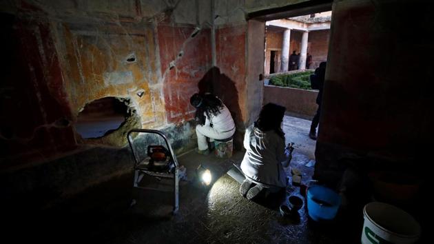 Archaeologists work on a fresco in the House of Lovers "Casa degli Amanti", one of three restored domus (ancient houses) reopened to the public at the archaeological site of Pompeii, Italy, February 18, 2020. REUTERS/Ciro De Luca (REUTERS)