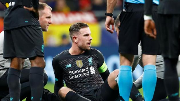 Liverpool's Jordan Henderson receives medical attention after sustaining an injury against Atletico Madrid.(REUTERS)