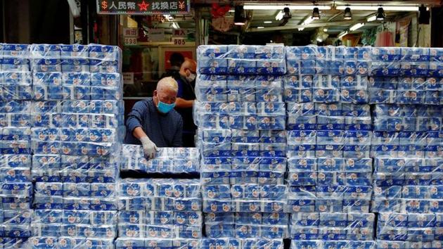 An employee restocks rolls of toilet paper at a market, in Hong Kong. Rumors that toilet paper and napkins could be used as masks emptied East Asian store shelves of paper goods. Three people with knives allegedly robbed a deliveryman outside a supermarket of precious toilet rolls reportedly worth more than 1,000 Hong Kong dollars. (Tyrone Siu / REUTERS)