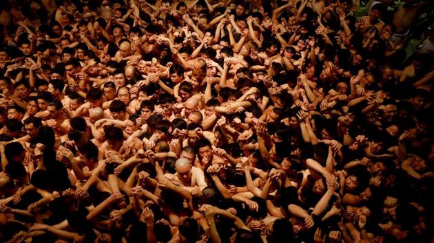 Men dressed in loincloths prepare to snatch a wooden stick called “shingi” tossed by the priest during a naked festival at Saidaiji Temple in Okayama, Japan. The person who grabs the wooden stick is considered the “luckiest man of the year”. (Kim Kyung-Hoon / REUTERS)