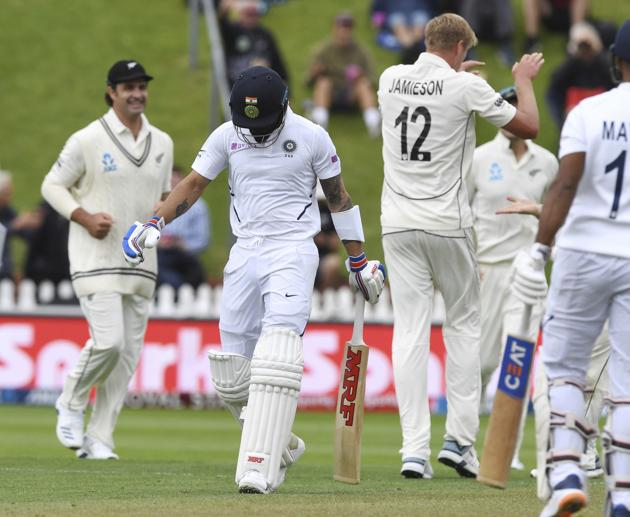 India's Virat Kohli, second left, walks from the field after he was dismissed by New Zealand's Kyle Jamieson during the first cricket test between India and New Zealand at the Basin Reserve in Wellington (AP)