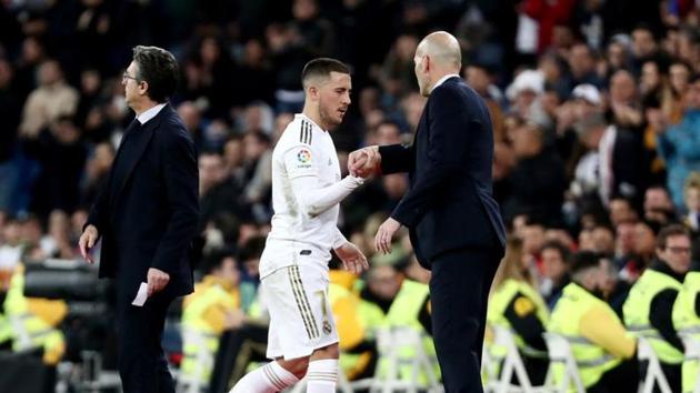 Soccer Football - La Liga Santander - Real Madrid v Celta Vigo - Santiago Bernabeu, Madrid, Spain - February 16, 2020 Real Madrid coach Zinedine Zidane with Eden Hazard as he is substituted(REUTERS)