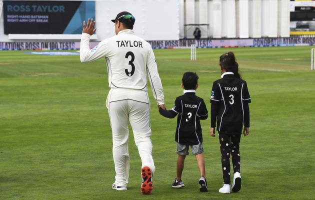 New Zealand's Ross Taylor with two of his children Jonty, left, and McKenzie, waves as he walks onto the field ahead of his 100th test match prior to the start of the first cricket test between India and New Zealand at the Basin Reserve in Wellington (AP)