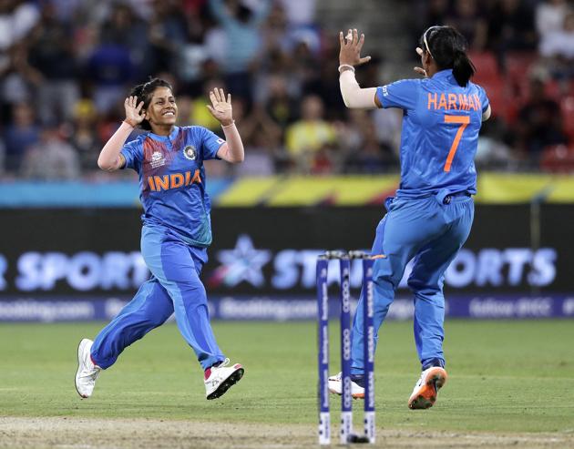 India's Poonam Yadav, left, celebrates with teammate Harmanpreet Kaur after taking the wicket of Australia's Jess Jonassen during the first game of the Women's T20 Cricket World Cup in Sydney. (AP)