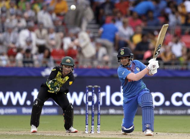 India's Shafali Verma, right, drives the ball for 4 runs as Australia's Alyssa Healy watches during the first game of the Women's T20 Cricket World Cup in Sydney. (AP)