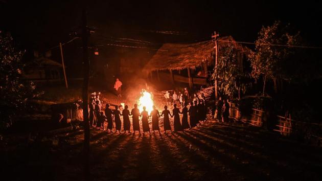 Naga tribeswomen around a fire during an overnight ceremony to bless the harvest in Satpalaw Shaung village, Lahe township in Myanmar's Sagaing region. A haunting refrain pierced the night as the tribeswomen of the Gongwang Bonyo, among the most isolated people in Myanmar, danced around a camp-fire to bless the harvest ahead. (Ye Aung Thu / AFP)