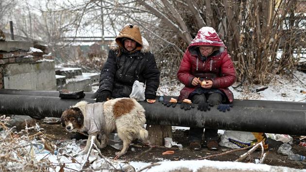 Sasha, 49, nicknamed “Poltorashka” (1.5-litre beverage bottle) and Lyusya Stepanova, 44, both of whom are homeless, sit on a warm pipe with their dog Bim, as they share a meal. It’s a perilous existence. Too far from the pipe and he could die of exposure to the cold. Too close and he could get severe burns without him noticing at first through the haze of hard alcohol that many drink to keep warm and dull reality. (REUTERS)