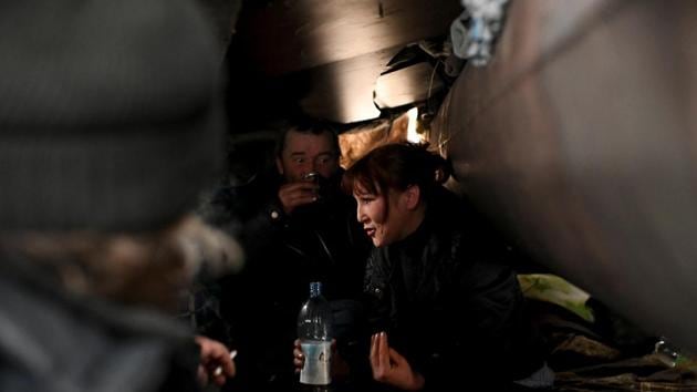 Alexei Vergunov, Andrey, nicknamed “Prizrachnyy Gonshchik” (ghost rider), and Galiya, 29, all of whom are homeless, have an alcoholic drink at Vergunov's shelter. Vergunov is one of 3,500 homeless people officially living rough in the city of Omsk, though the real figure is likely higher. (REUTERS)