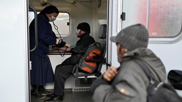A nun checks the blood pressure of a man who is homeless, during an event organised by Caritas, a charity that hands out food and clothes to help the city’s homeless. Vergunov, however, has also learned to be on the lookout for ill-wishers. He once saved the life of his friend, Alexander, after a group of teenagers set him on fire. (REUTERS)