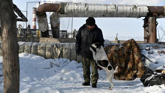 Alexei Vergunov, nicknamed “Lyokha Boroda” (Lyokha the beard), who is homeless, stands near his makeshift shelter with his dog Bella, in Omsk, Russia. Like many of Siberia’s homeless, Alexei Vergunov survives freezing night-time temperatures of -30 degrees Celsius by sleeping under an industrial heating pipe for warmth. (Alexey Malgavko / REUTERS)