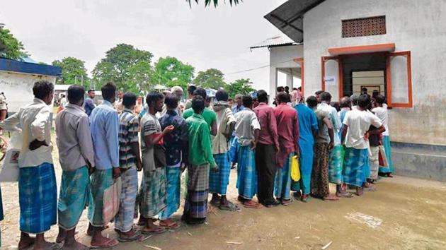 People check their names in final NRC list in Assam in 2019.(AFP)