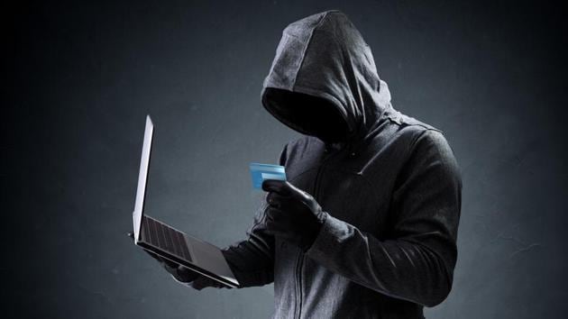 Computer hacker with credit card stealing data from a laptop concept for network security, identity theft and computer crime (Getty Images/iStockphoto) Computer hacker with credit card stealing data from a laptop concept for network security, identity theft and computer crime (Getty Images/iStockphoto)