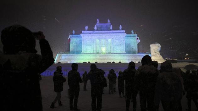 Tourists gather in front of a large snow sculpture of Poland's Palace on the Isle during the annual Sapporo Snow Festival at Odori Park. The snowfall was good news for tourism, for the “look” of the annual Sapporo Snow Festival, and for organizers who hope to bring the 2030 Winter Olympics to the city. Sapporo hosted the Winter Olympics back in 1972. (Jae C. Hong / AP)