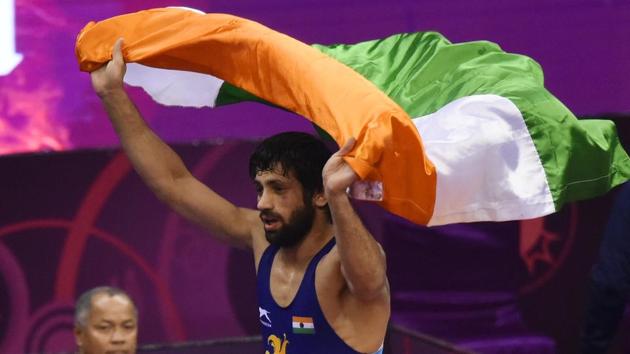 Ravi Kumar Dahiya (in blue) from India carries the tricolour after winning his bout against Tajikistan’s Vohidov Hikmatullo(Vipin Kumar/HT PHOTO) Ravi Kumar Dahiya (in blue) from India carries the tricolour after winning his bout against Tajikistan’s Vohidov Hikmatullo(Vipin Kumar/HT PHOTO)
