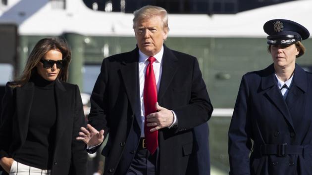 President Donald Trump with first lady Melania Trump wave as they walk across the tarmac to board Air Force One at th Andrews Air Force Baseduring their departure to India onSunday.(AP PHOTO.)