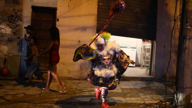A "Bate-bola" (slam the ball) reveler performs during the traditional carnival festivity in the suburb in Rio de Janeiro, Brazil.(REUTERS)
